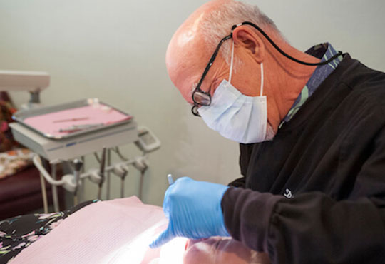 Doctor performing oral surgery